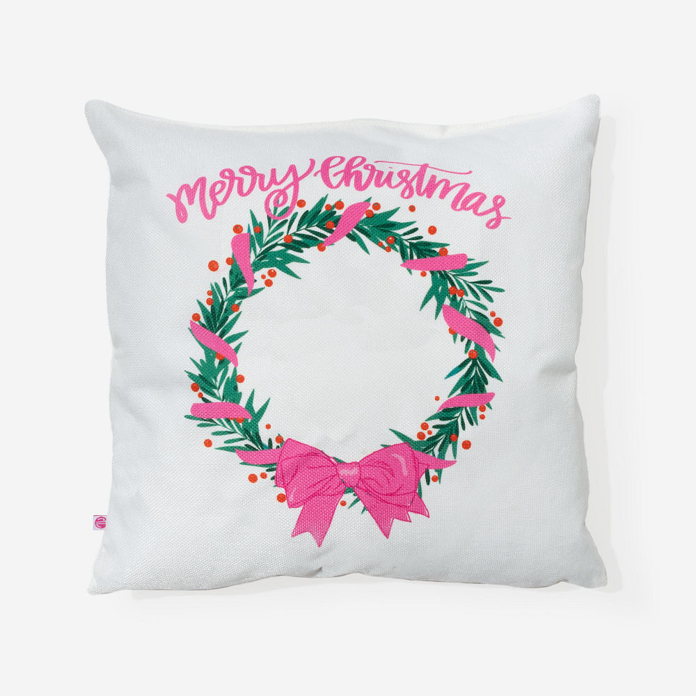 girl holding monogrammed holiday wreath pillow