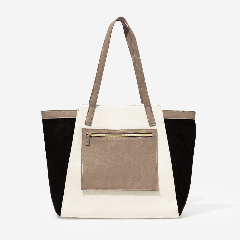 taupe colorblock tote bag on arm with split initials