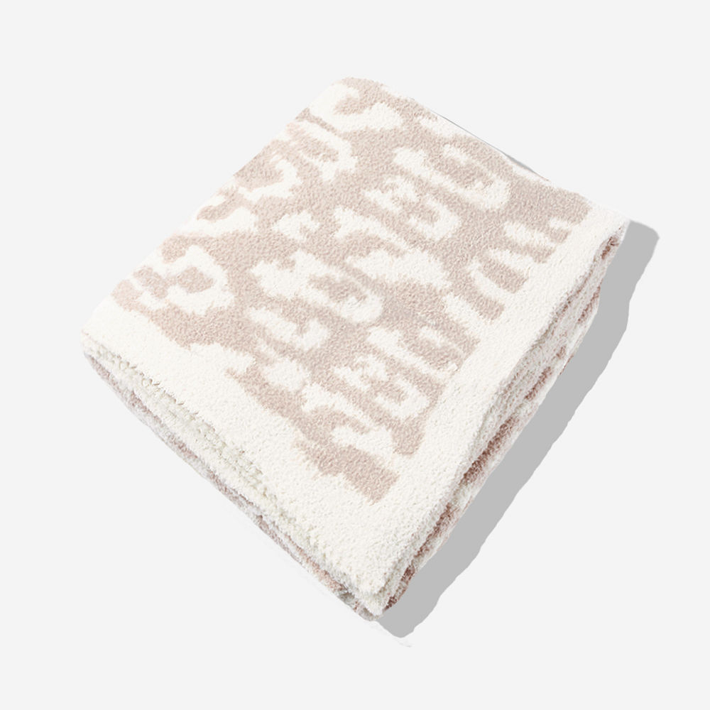 neutral leopard personalized cozy blanket on bed
