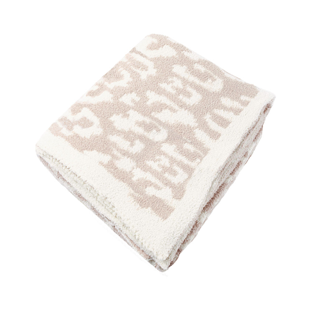 neutral leopard personalized cozy blanket on bed