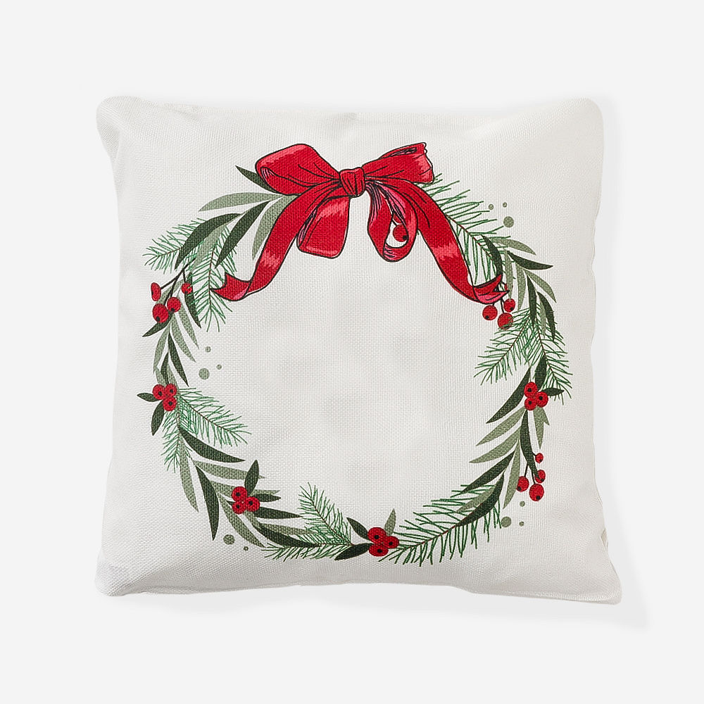 girl holding monogrammed holiday wreath pillow