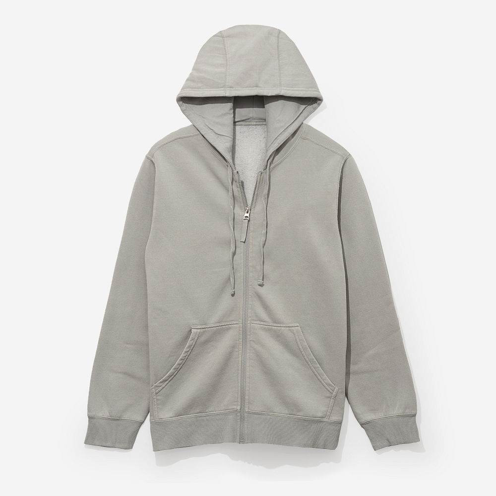 girl wearing grey monogrammed hooded sweatshirt jacket