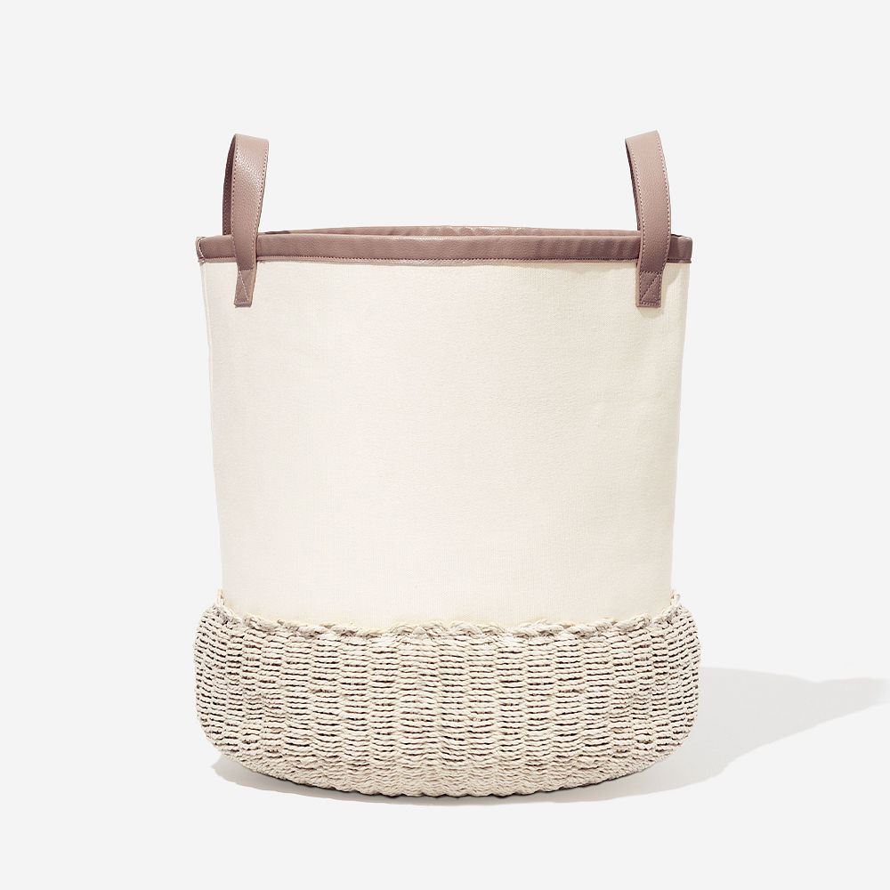 tan and ivory storage basket with blankets and magazines