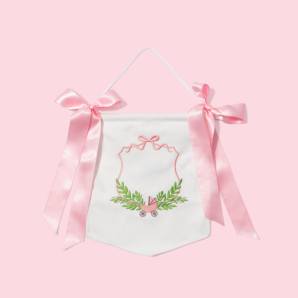 pink new baby banner on window