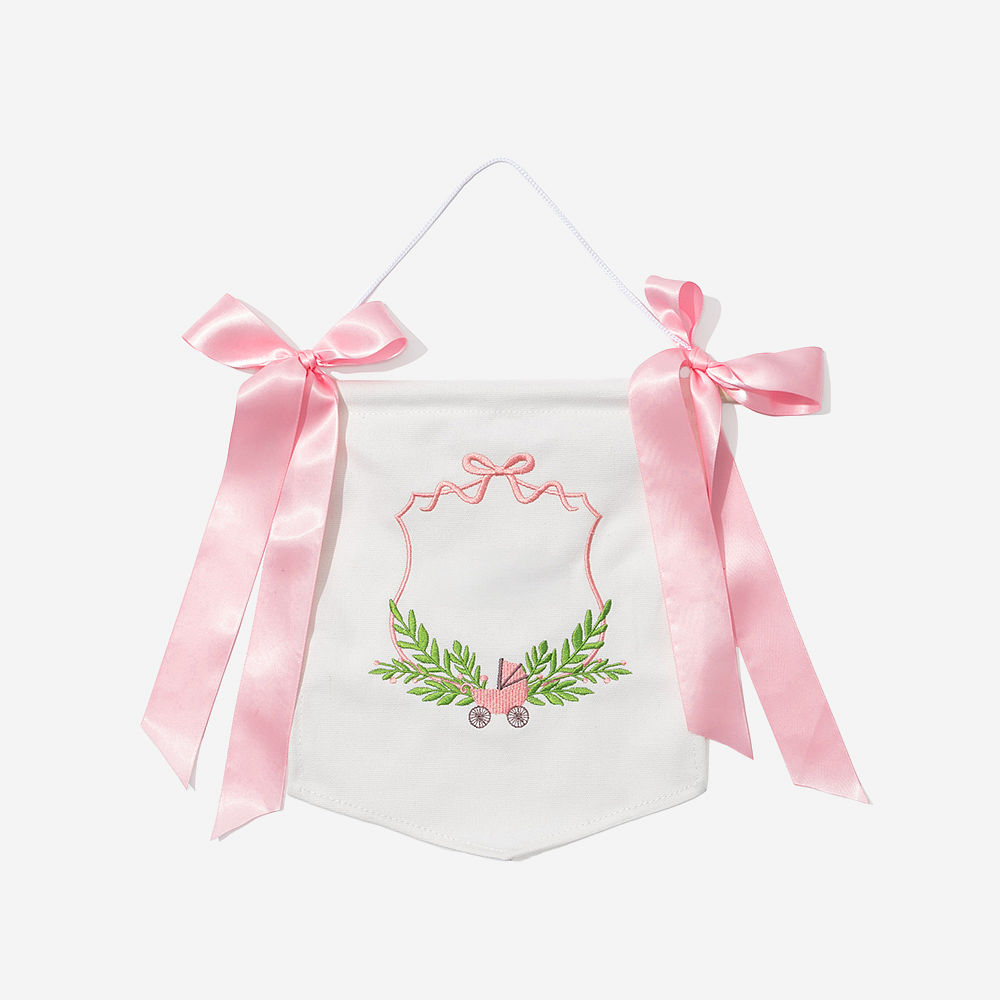 pink new baby banner on window