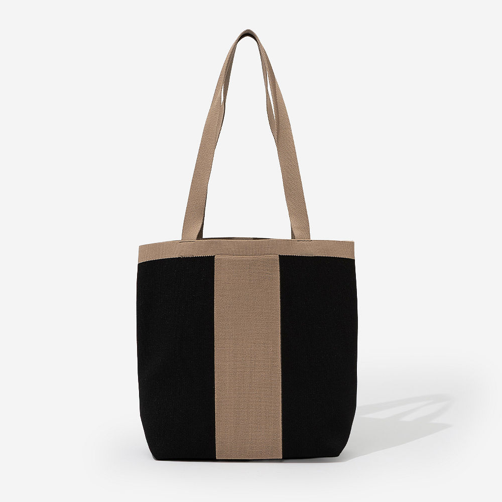 monogrammed tan ivory knit tote at angle in studio