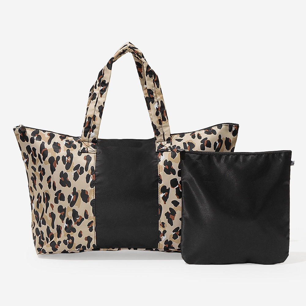 coral botanical packable weekend duffel over map