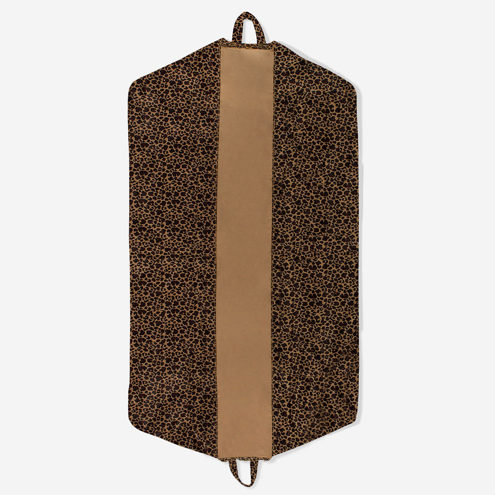 leopard packable garment bag and duffel on sheet