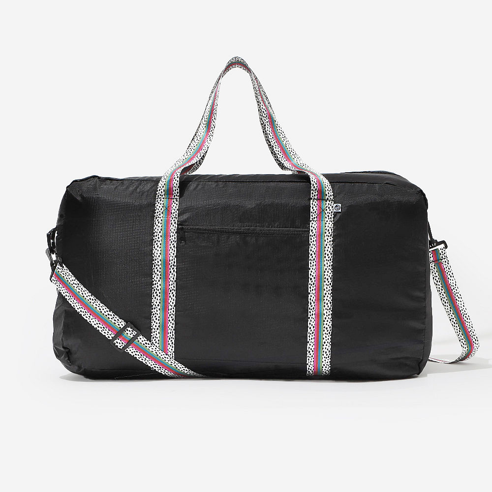 packable black spottie monogrammed weekender duffle in suitcase