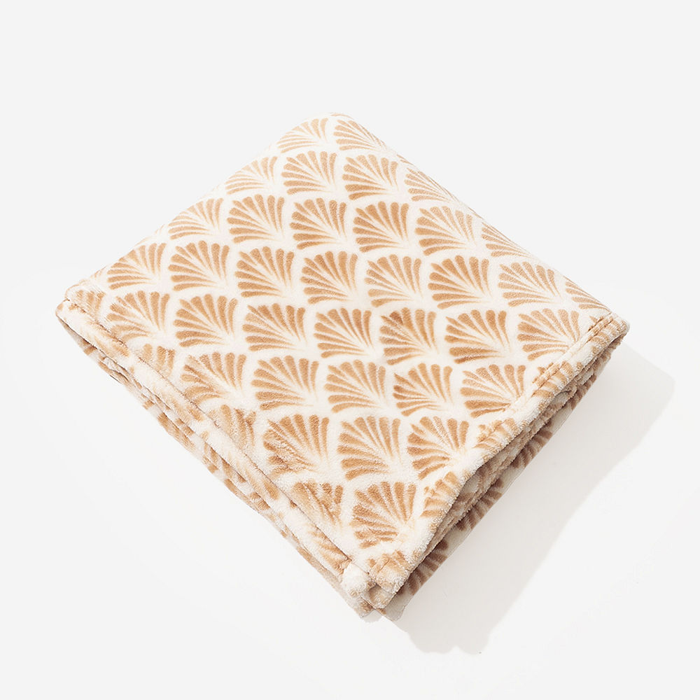 neutral herringbone plush blanket on couch