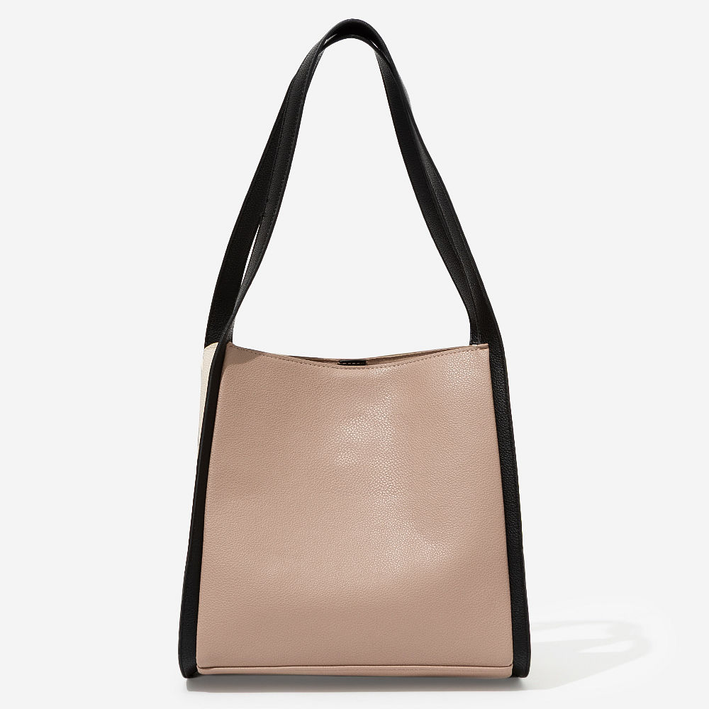 girl holding monogrammed shoulder tote in brown