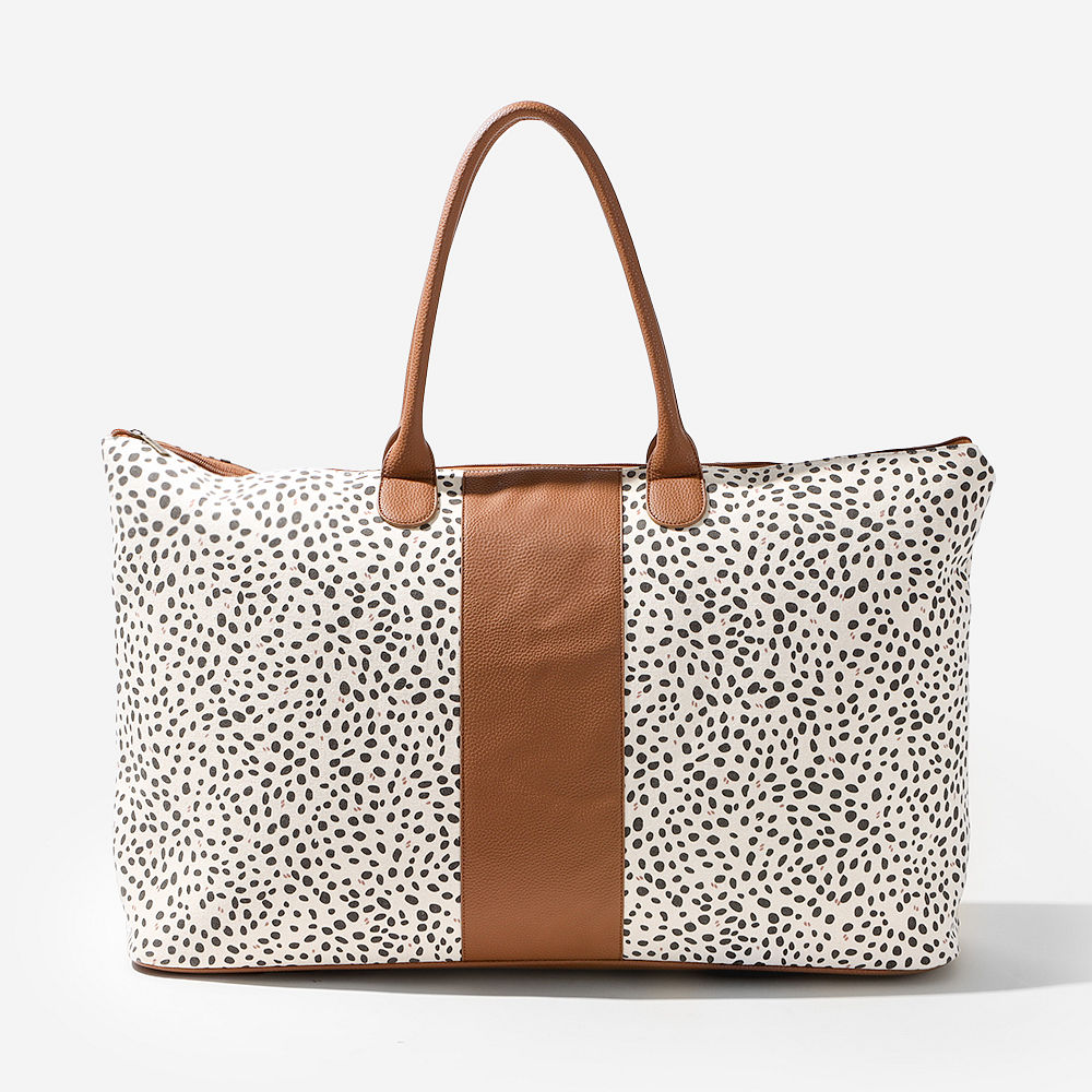 monogrammed spotted weekender with matching tote bag in back of car