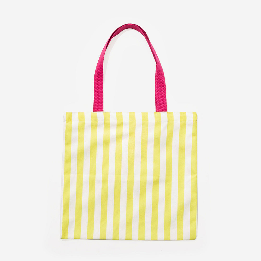 yellow and pink striped tote open on grass