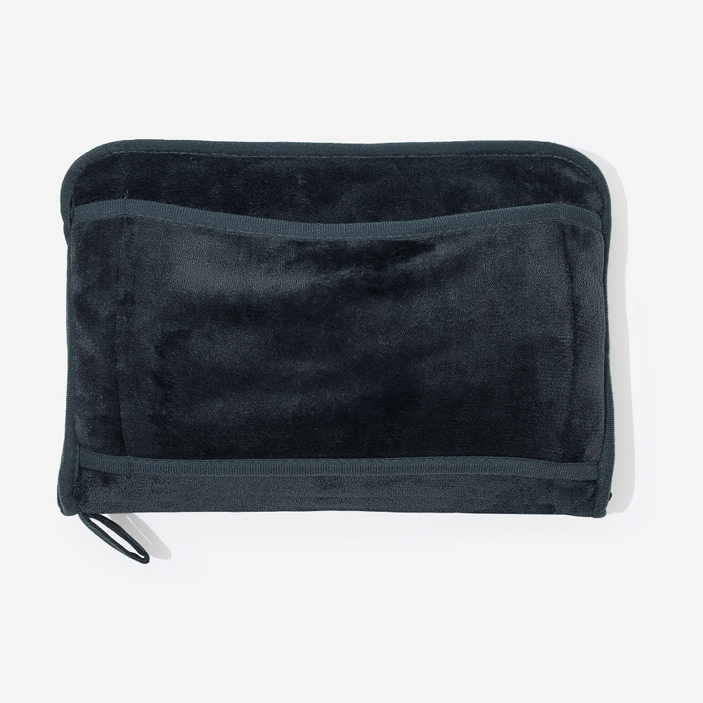 man holding monogrammed charcoal travel blanket pillow