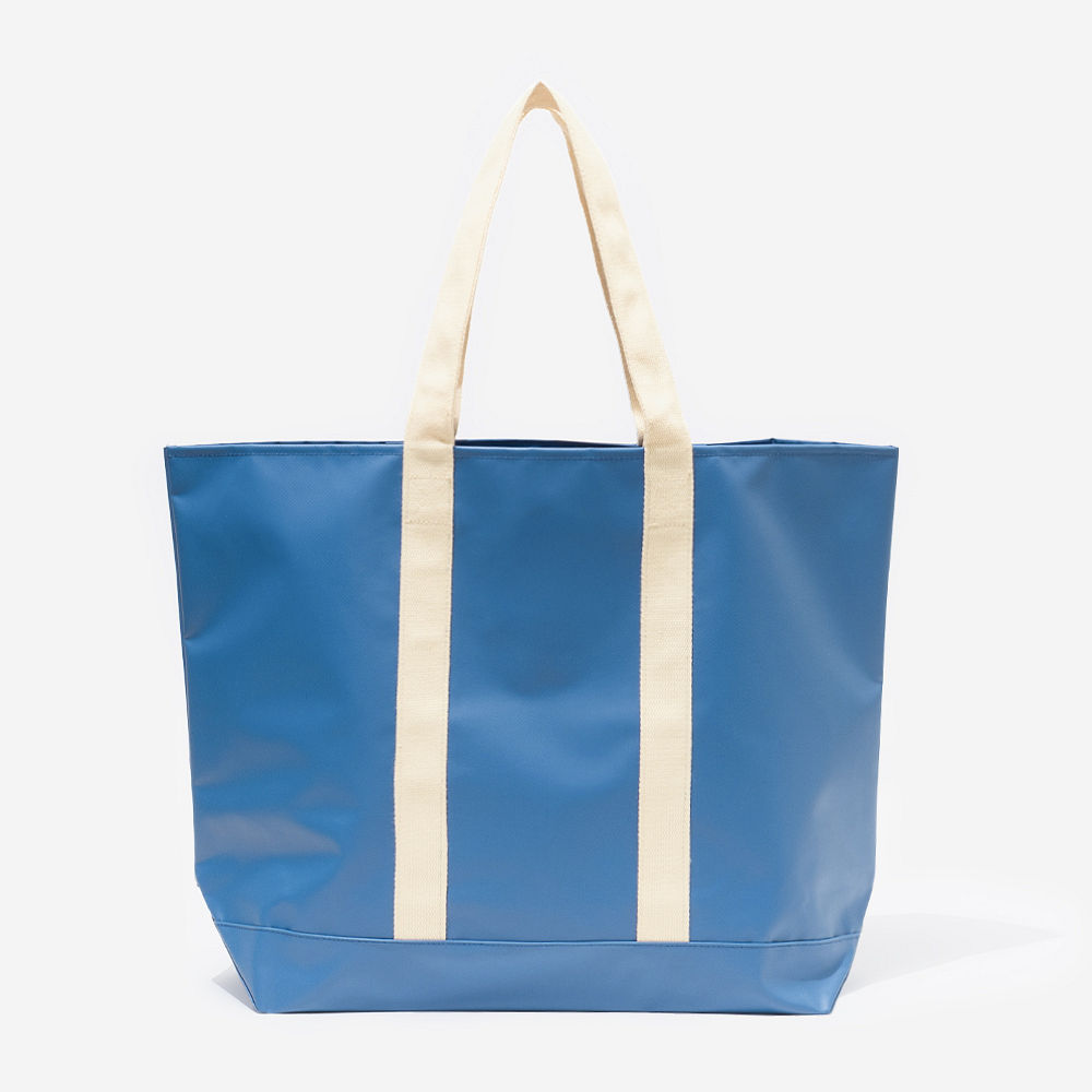 blue waterproof tote on beach