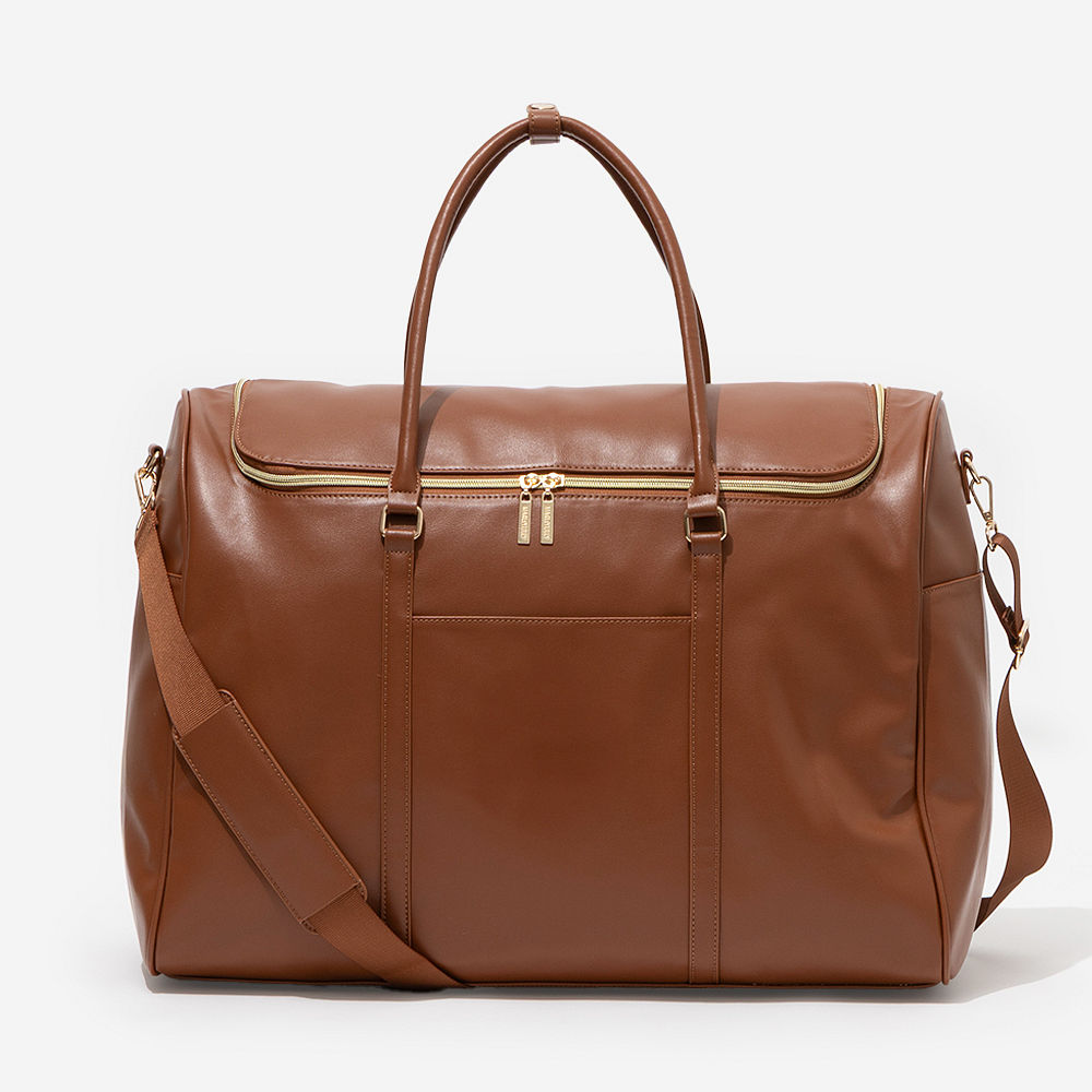 brown weekend travel bag on shoulder