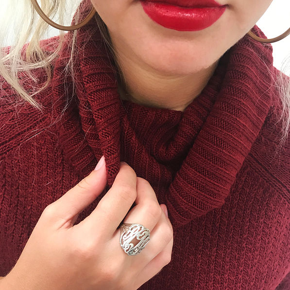 sterling silver cut out ring on hand burgundy turtleneck sweater