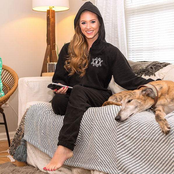 monogrammed fleece footed pajamas on girl with dog on couch