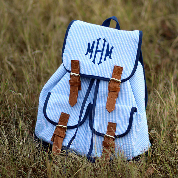 blue monogrammed seersucker backpack in grass