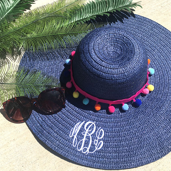 monogrammed navy straw hat with pom poms