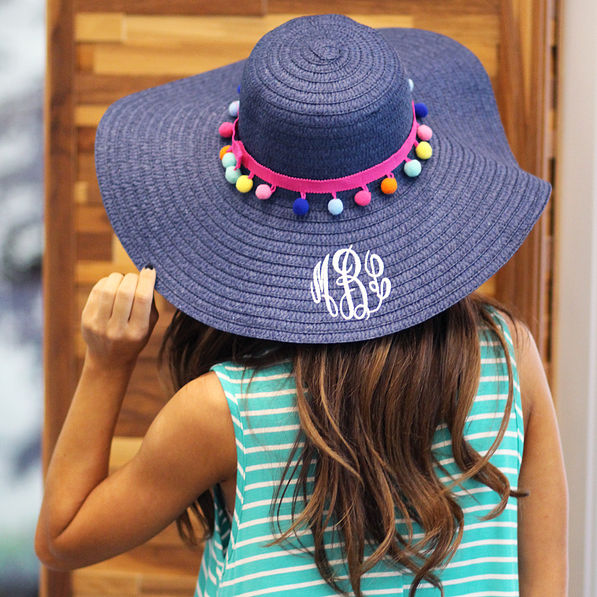 embroidered navy straw hat with colorful poms