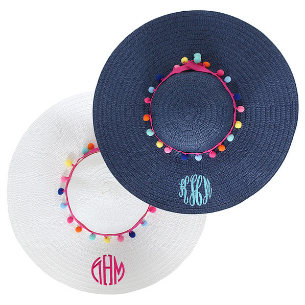 navy and white straw sun hats with monograms and pom poms