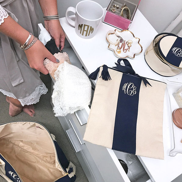 Girl packing her navy Monogrammed Lingerie Bag