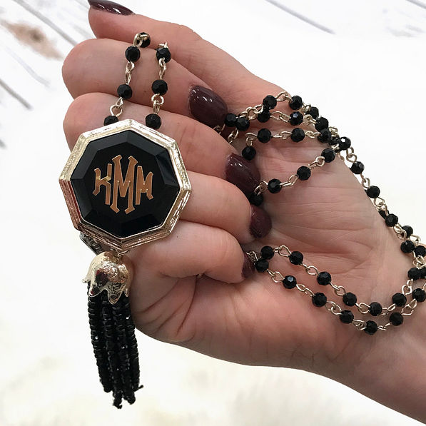 Model holding Tassel Pendant Necklace with Rosary Beads