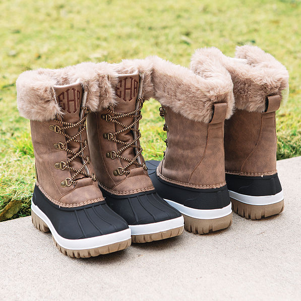 monogrammed snow winter brown duck boots on sidewalk