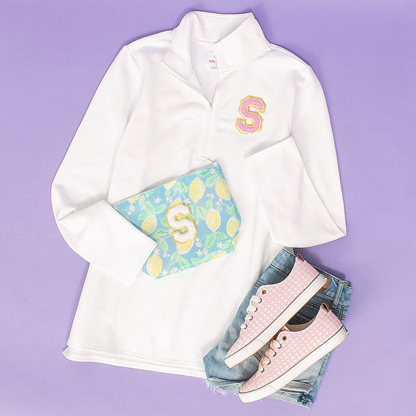 Chenille Large Letter in White and pink on packing bag and pullover sweatshirt and gingham sneakers