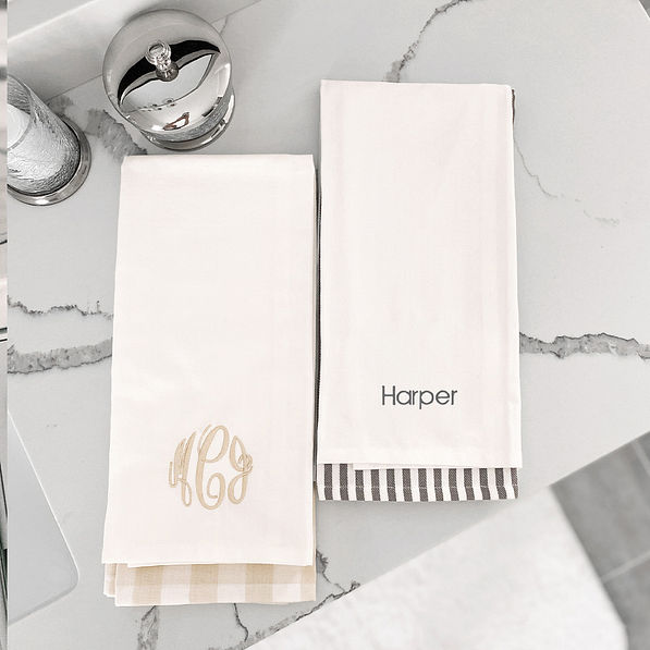 monogrammed hand towel set in both colors on marble
