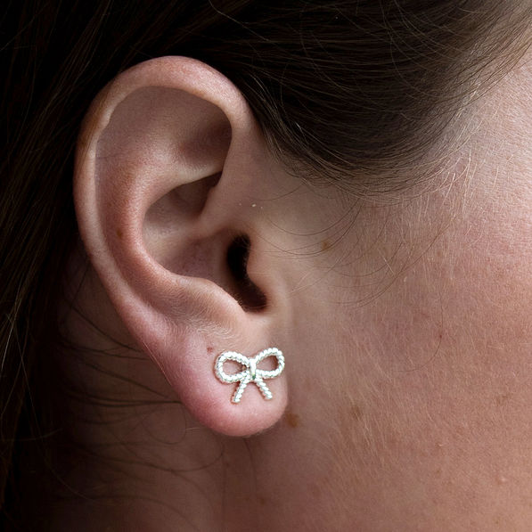 bow earrings on ear