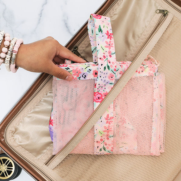 coral floral monogrammed packable laundry bag in luggage