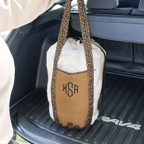 monogrammed leopard packable laundry bag in trunk of car