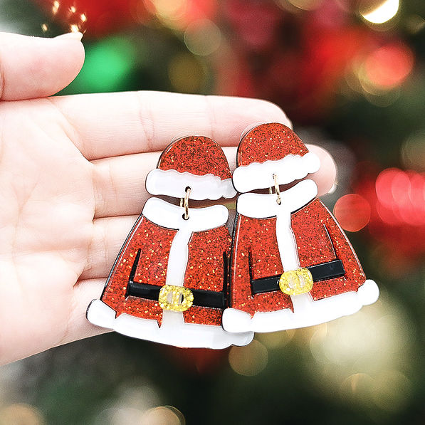girl holding santa earrings