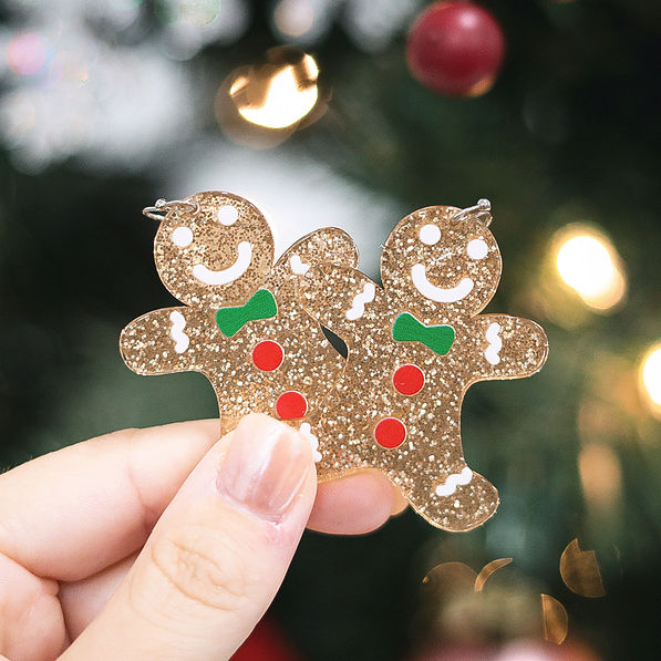 gingerbread earrings with tree behind them