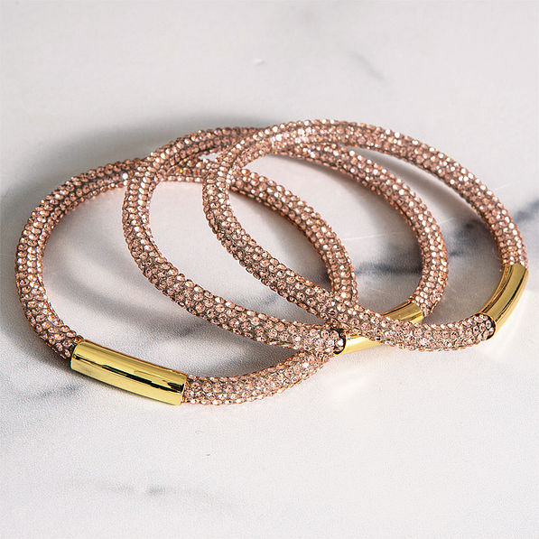 close up of rose gold bangle set