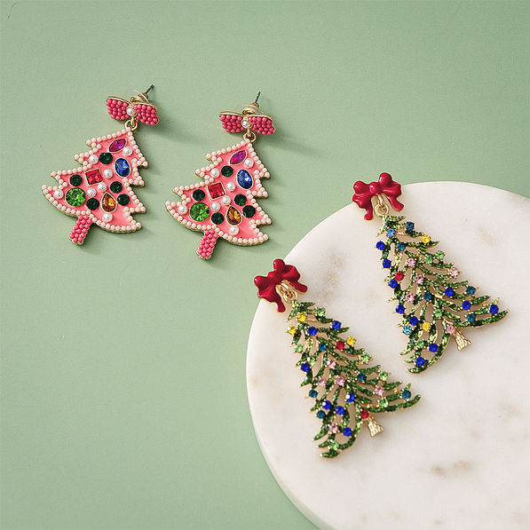 beaded christmas earrings in green and pink on green background