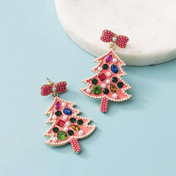 beaded christmas earrings in pink on blue background