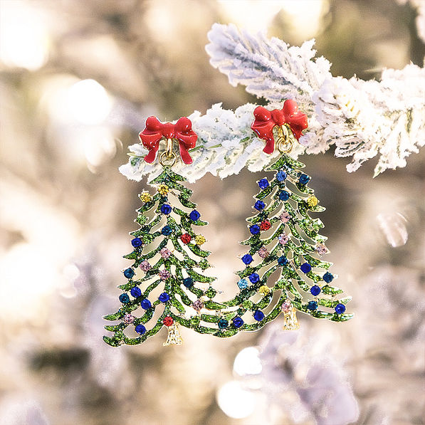 beaded christmas earrings in green hanging on winter tree