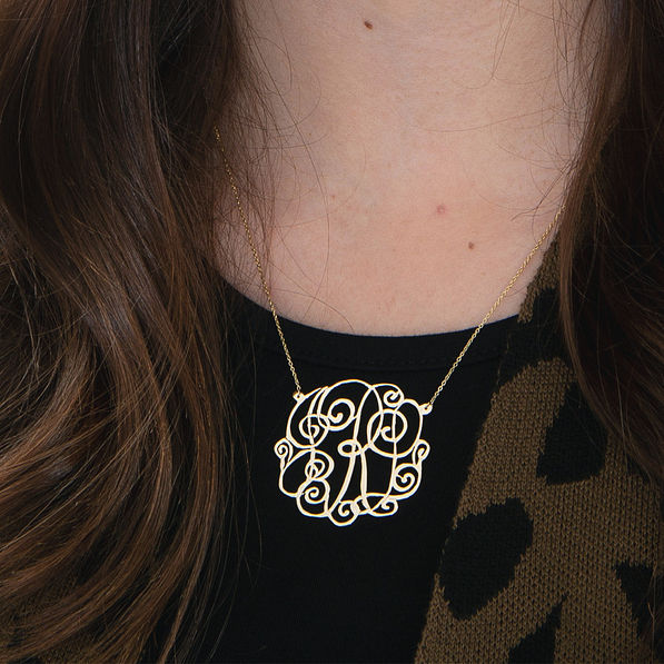 girl wearing gold monogrammed lacey necklace