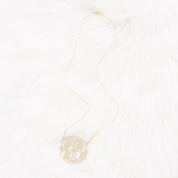 gold monogrammed lacey necklace on faux fur