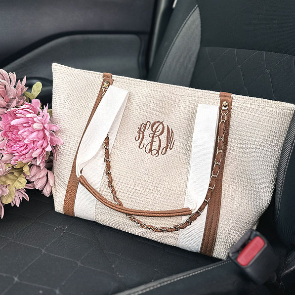 ivory monogrammed charlotte handbag in car