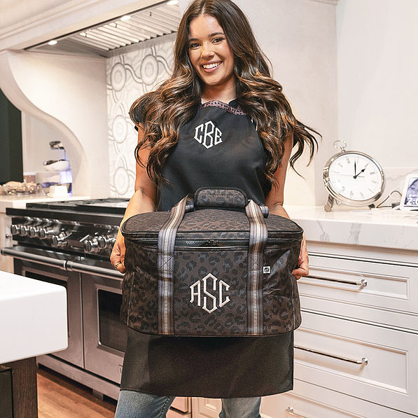 girl carrying monogrammed slow cooker carrier in sable cheetah
