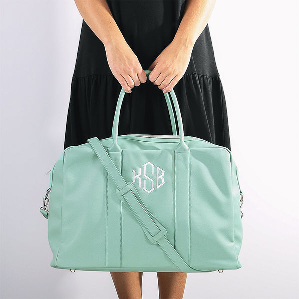 Girl holding Mint Duffel Bag