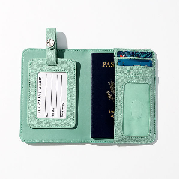 passport inside of monogrammed passport carrier case and luggage tag in mint
