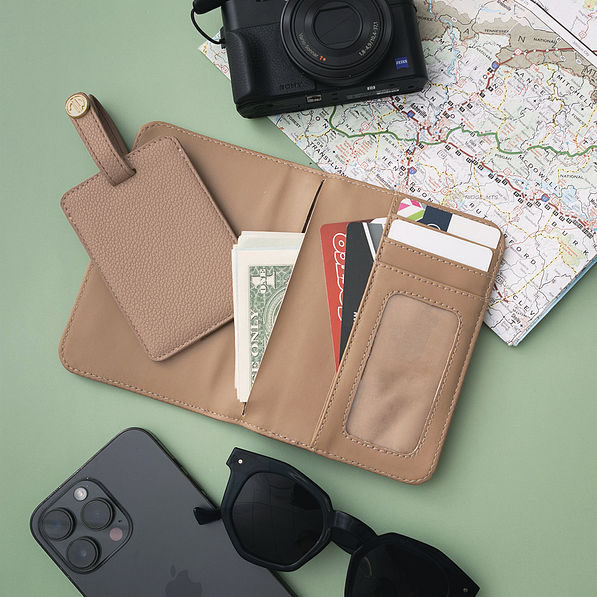 inside of monogrammed passport carrier case and luggage tag in taupe