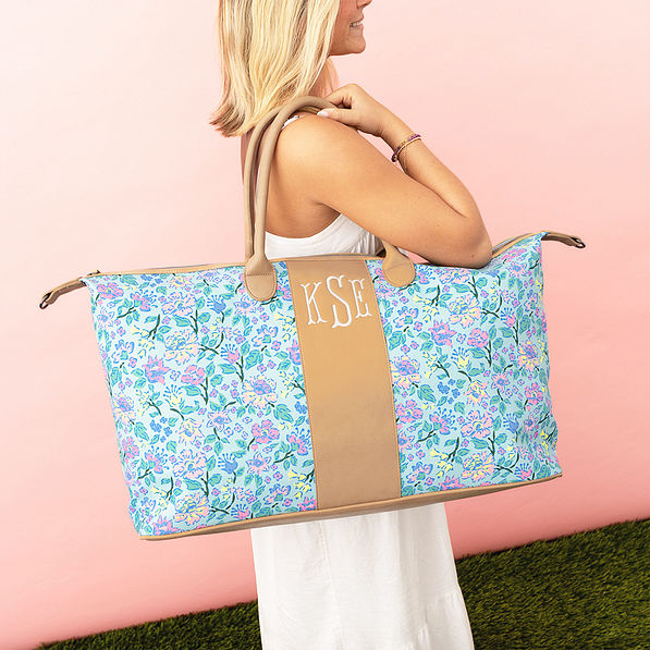 pastel flora trellis charleston weekender on girls shoulder