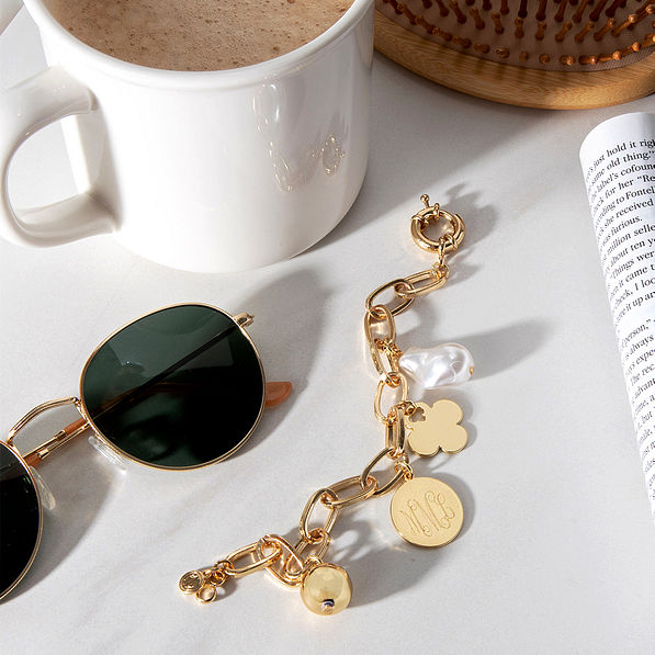 Monogrammed Link Charm Bracelet on table with sunglasses, book and coffee