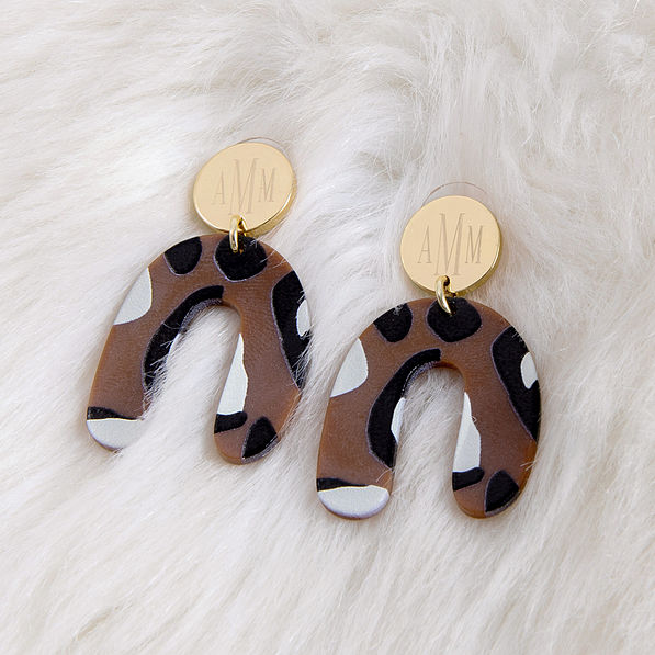 Monogrammed Leopard Arch Earrings on furry rug